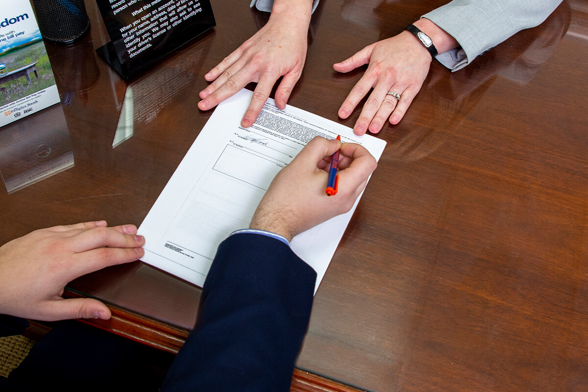 Signing loan documents.