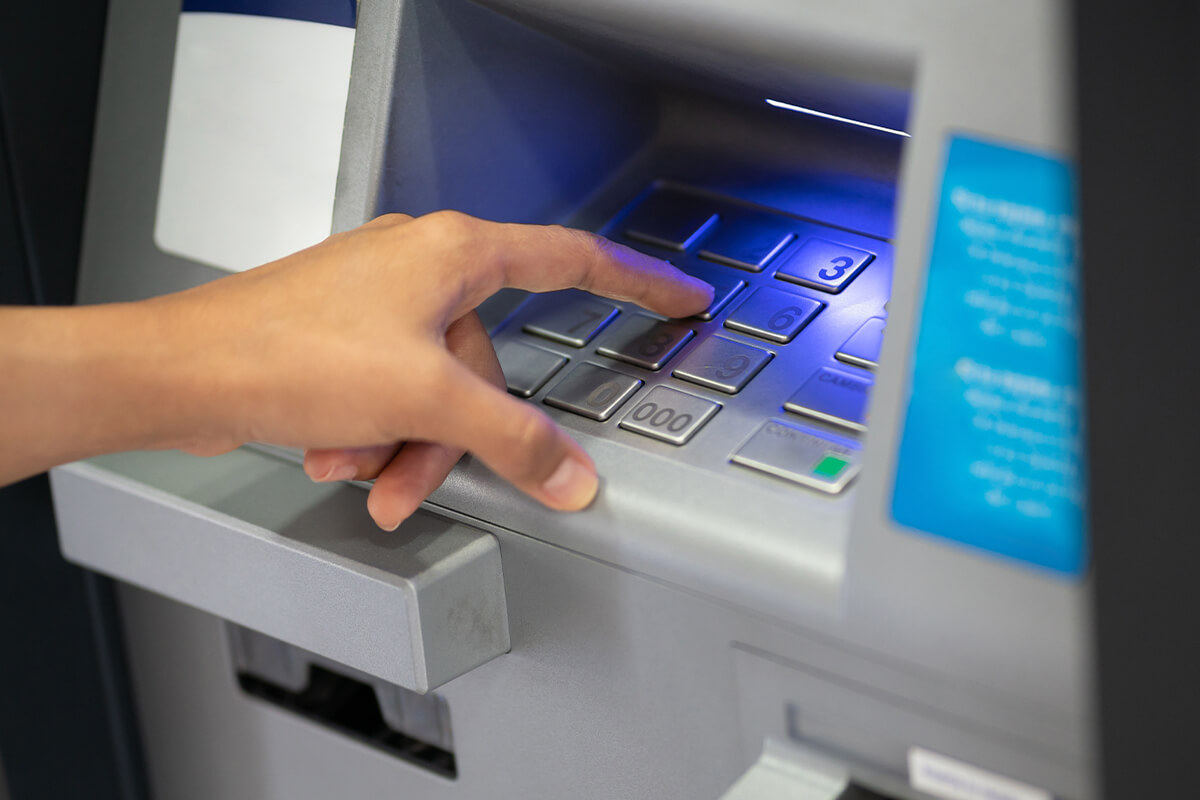 Photo of a person using an ATM